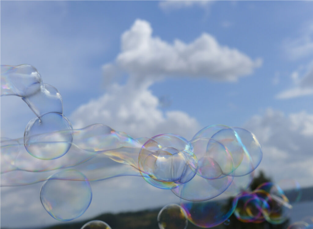 Soap bubbles ejected from a propeller-driven soap wand.
